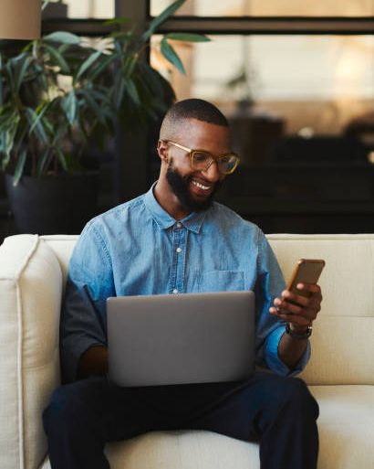 Business owner using Fundfast on his phone and laptop